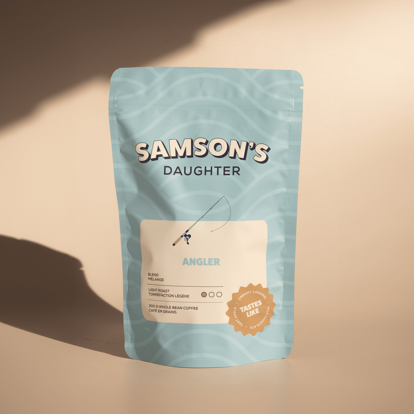 A bag of Angler light roast with a light brown background in hard light.